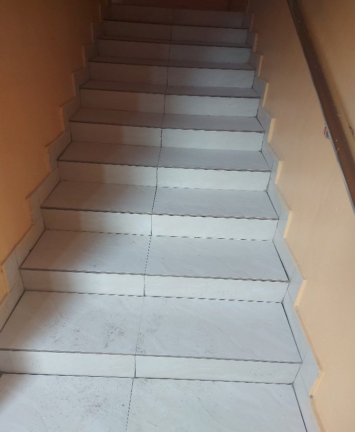 Completed staircase tiling with hand railings